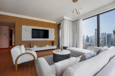 a living room with a white couch and a tv at boulevard point view in Dubai