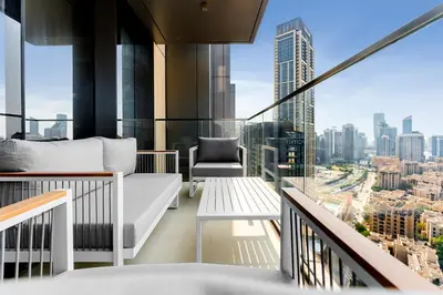 a balcony with a couch and a chair on a building at boulevard point view in Dubai