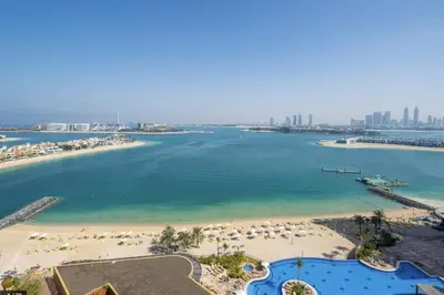 an aerial view of a beach with umbrellas at Tiara Residence - Palm Jumeirah Dubai in Dubai