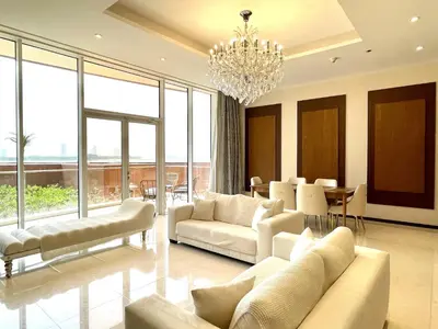 a living room with white furniture and a chandelier at Tiara Residence - Palm Jumeirah Dubai in Dubai