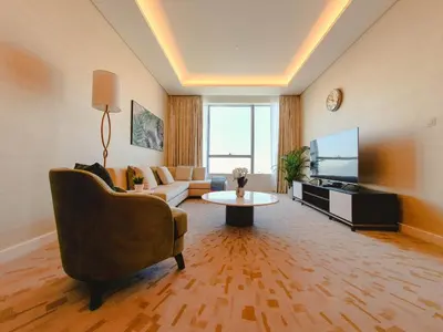 a living room with a couch and a tv at ORION in Dubai