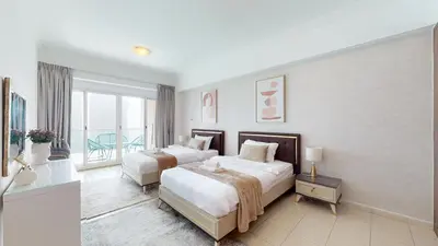 a hotel room with two beds and a balcony at LV38 - Elegant 2BHK in Lake View Tower in Dubai