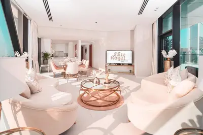 a living room with white furniture and a table at Elite Royal Apartment - Panoramic Burj Khalifa, Fountain & Dubai skyline view - Marquise in Dubai