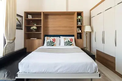 a bedroom with a large bed with a wooden headboard at Frank Porter - Starz by Danube in Dubai