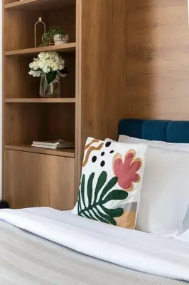 a bedroom with a bed with a pillow and a shelf at Frank Porter - Starz by Danube in Dubai