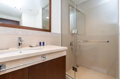 a bathroom with a sink and a shower at Vacay Lettings - High floor Burj Khalifa & Fountain view 3 bed in Dubai