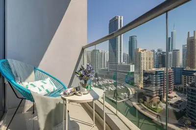 a balcony with a table and a view of a city at Frank Porter - Marina Wharf 2 in Dubai