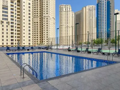 a large swimming pool in a city with tall buildings at Frank Porter - Marina Wharf 2 in Dubai