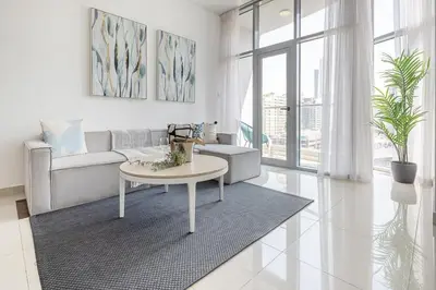 a living room with a couch and a table at Frank Porter - Marina Wharf 2 in Dubai