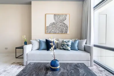 a living room with a couch and a vase at Silkhaus contemporary 1BDR with Downtown view in DIFC in Dubai
