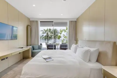 a hotel room with a large white bed and a desk at FIVE Palm Beachfront Villa -Private Pool & Jacuzzi, Panoramic Views, by Exclusive Holiday Homes in Dubai