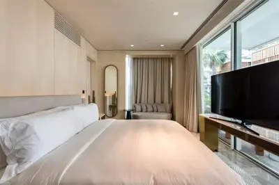 a bedroom with a large bed and a flat screen tv at FIVE Palm Beachfront Villa -Private Pool & Jacuzzi, Panoramic Views, by Exclusive Holiday Homes in Dubai