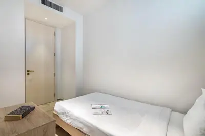 a small bedroom with a bed and a table at FIVE Palm Beachfront Villa -Private Pool & Jacuzzi, Panoramic Views, by Exclusive Holiday Homes in Dubai