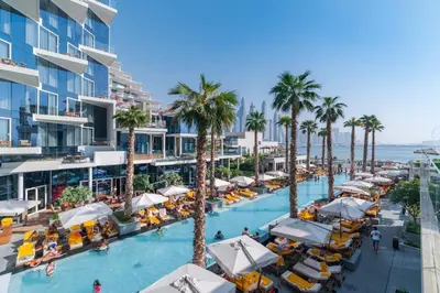 an aerial view of a resort swimming pool with palm trees at FIVE Palm Beachfront Villa -Private Pool & Jacuzzi, Panoramic Views, by Exclusive Holiday Homes in Dubai