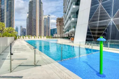a swimming pool in a city with tall buildings at Maison Privee - Luxury Apt with Burj Khalifa Vw & Dubai Canal Access in Dubai