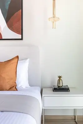 a bedroom with a bed and a side table at Frank Porter - The Address JBR in Dubai