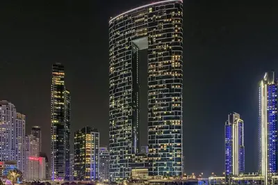 a tall building in a city at night at Frank Porter - The Address JBR in Dubai