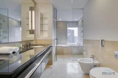 a bathroom with a toilet and a sink at Steps Away From Marina Mall with Iconic Marina Canal Views, The Address Residences, Dubai Marina by Deluxe Holiday Homes in Dubai