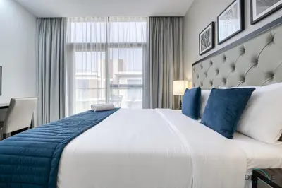 a bedroom with a large bed with a large window at Superb Studio at Damac Celestia A Dubai South By Deluxe Holiday Homes in Dubai