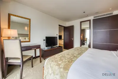 a hotel room with a bed and a desk and a television at Marina Gem with Overlooking Canal Views 1BR Next to Mall, The Address Residences, Dubai Marina by Deluxe Holiday Homes in Dubai
