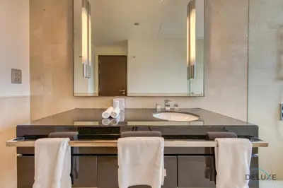 a bathroom with a counter with a sink and a mirror at Marina Gem with Overlooking Canal Views 1BR Next to Mall, The Address Residences, Dubai Marina by Deluxe Holiday Homes in Dubai