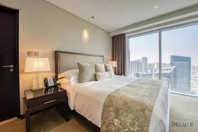 a bedroom with a large bed and a large window at Marina Gem with Overlooking Canal Views 1BR Next to Mall, The Address Residences, Dubai Marina by Deluxe Holiday Homes in Dubai