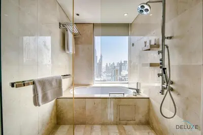 a bathroom with a tub and a shower with a window at Pristine 3BR at The Address Residences Dubai Marina by Deluxe Holiday Homes in Dubai