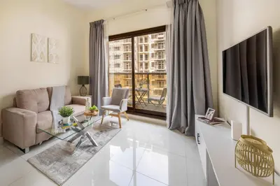 a living room with a couch and a glass table at Frank Porter - Elite Sports Residence in Dubai