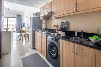 a kitchen with a washer and a sink and a refrigerator at Frank Porter - Elite Sports Residence in Dubai