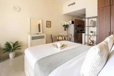 a bedroom with a large white bed in a room at Frank Porter - Elite Sports Residence in Dubai