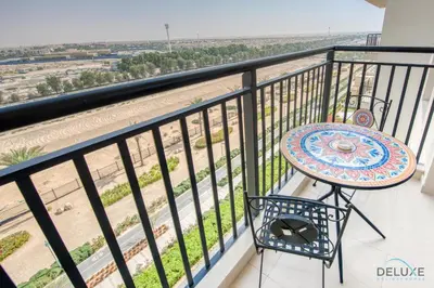 a balcony with a table and a view of the beach at Fancy 2BR at Hayat Boulevard 2A Town Square By Deluxe Holiday Home in Dubai
