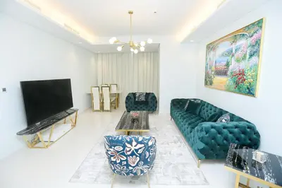 a living room with a couch and a flat screen tv at Paramount Midtown -Stunning 2 Bedroom Apt with Burj-Khalifa view in Dubai