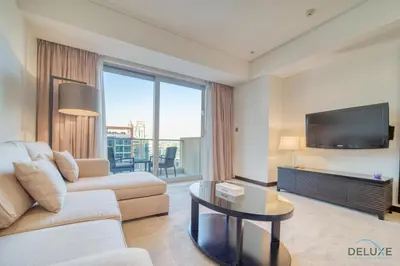 a living room with a couch and a tv at Pristine 1BR in The Address Residences Dubai Marina by Deluxe Holiday Homes in Dubai