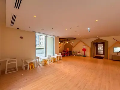 an empty room with tables and chairs and a large window at Frank Porter - Creek Horizon T2 in Dubai