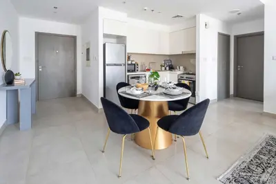 a kitchen and dining room with a table and chairs at Frank Porter - Creek Horizon T2 in Dubai