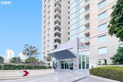 an external view of a tall building with a red arrow at Designer apartment on the Marina Walk in Dubai