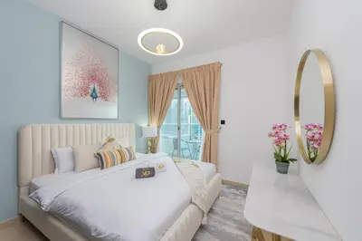 a bedroom with a white bed and a mirror at Marco Polo - Find your calm escape in Dubai Marina in Dubai