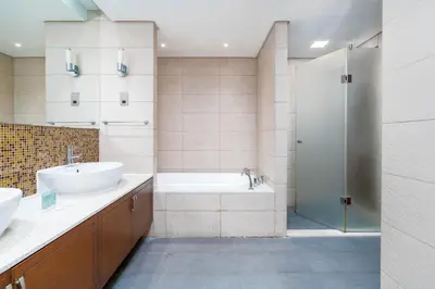 a bathroom with a tub and a sink and a shower at Ahlan HH - Luxurious Apartment with Beach Access and Sea View at Palm Jumeirah in Dubai