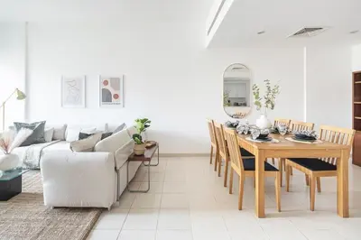 a living room with a table and a couch at Frank Porter - Al Samar in Dubai
