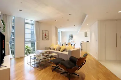 a living room with a white couch and chairs at Livbnb - Tranquil 2BR in Bluewaters in Dubai