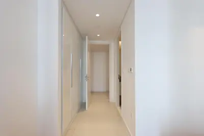 a hallway with white walls and a long corridor at Livbnb - Tranquil 2BR in Bluewaters in Dubai