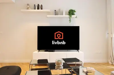 a living room with a flat screen tv on a white entertainment center at Livbnb - Tranquil 2BR in Bluewaters in Dubai