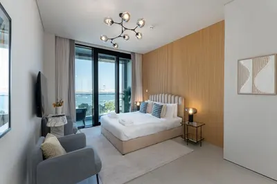 a bedroom with a bed and a couch and a chair at Address JBR Sea View, Jumeirah Beach Residence, Dubai Marina - Mint Stay in Dubai