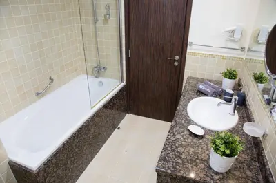 a bathroom with a sink and a bath tub and a sink at HiGuests - Charming Apt in JBR with Balcony by the Beach in Dubai