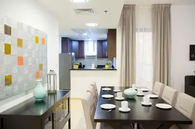 a dining room with a black table and chairs at HiGuests - Charming Apt in JBR with Balcony by the Beach in Dubai