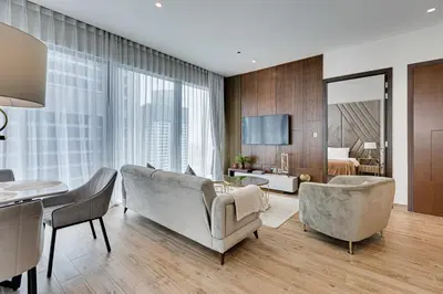 a living room with a couch and chairs and a bedroom at Luxury 2BD apartment in MarinaGate Jumeirah Living in Dubai