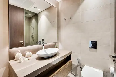 a bathroom with a sink and a mirror at Luxury 2BD apartment in MarinaGate Jumeirah Living in Dubai