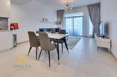 a dining room and living room with a table and chairs at Luxury 1BD apartment in Madinat Jumeirah Living in Dubai