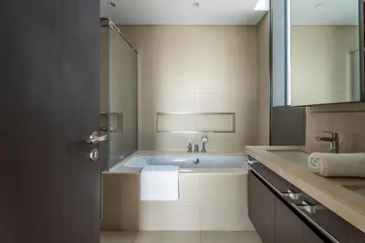 a bathroom with a bath tub and a sink at GuestReady - Luxury Tower with Burj Khalifa View in Dubai