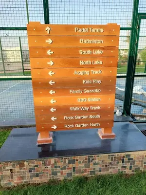 a wooden sign with different words on it at Spacious, Economical Apt Near Miralcz Garden in Dubai
